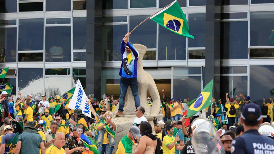 Supporters of Brazilian former President Jair Bolsonaro invade Planalto Presidential Palace while clashing with security forces in Brasilia on January 8, 2023. 
