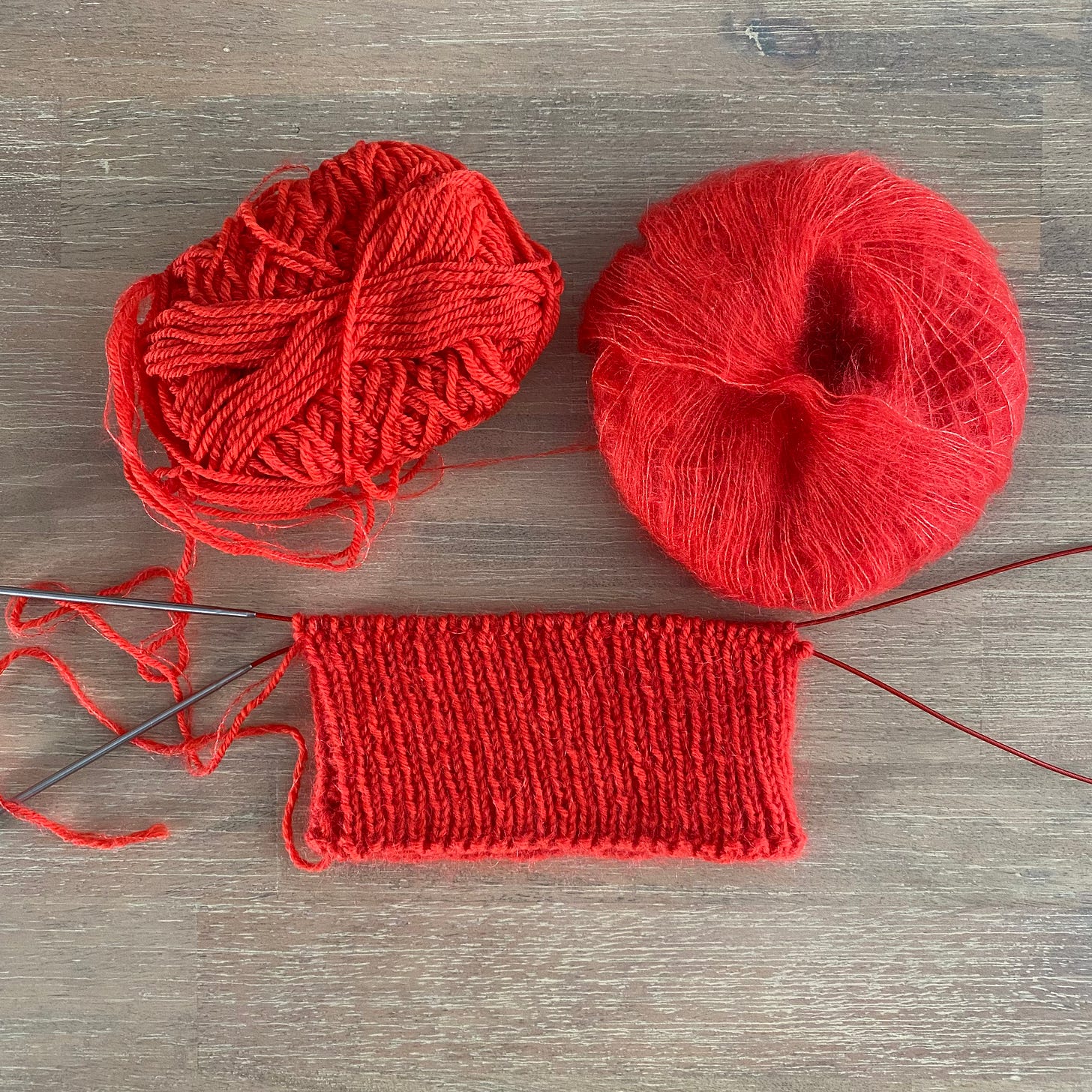 Two balls of yarn and a knitted hat brim