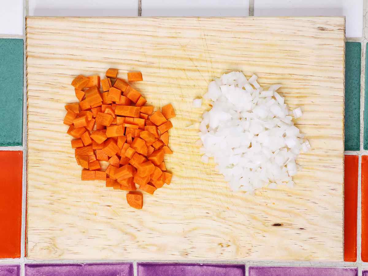 Diced Carrots and Onions on Cutting Board