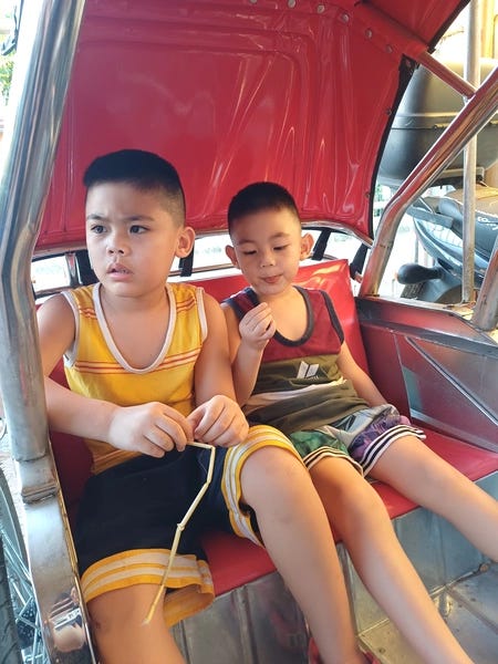 Miguel and Rafa in Lolo's tricycle