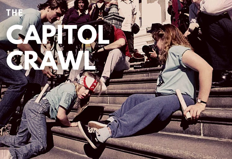 A group of disabled people including 8-year-old Jennifer Keelan crawl up the steps of the U.S. Capitol in Washington. Photo by Jeff Markowitz/AP Photo