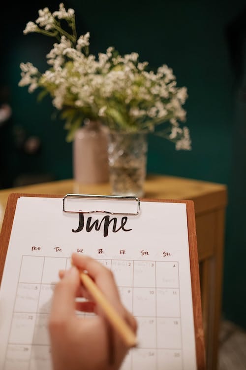 Free Person Holding a Calendar and Clipboard Stock Photo