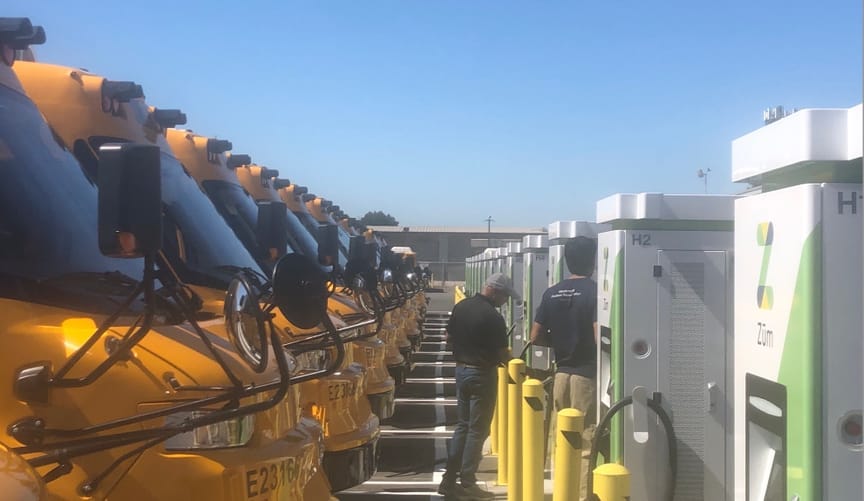 Electric school buses and bidirectional chargers at the depot operated by startup Zum for the Oakland Unified School District