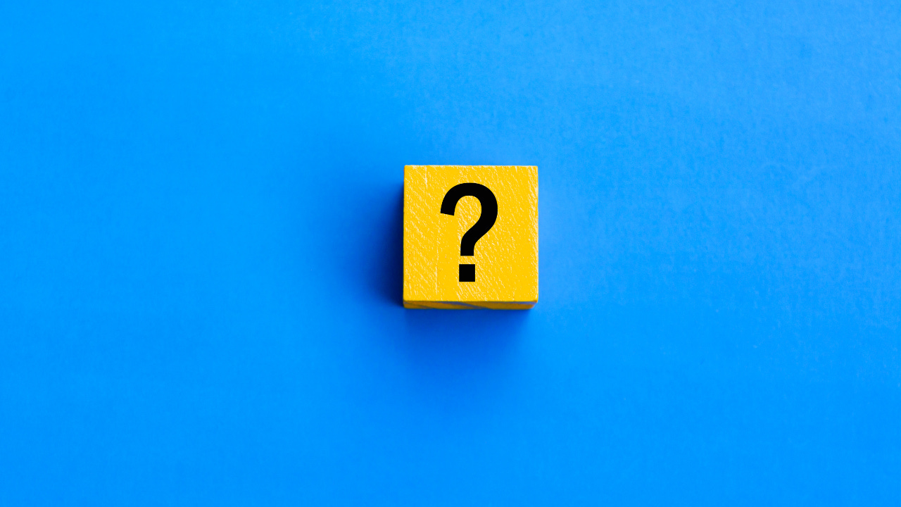 A question mark on a yellow block against a blue background.