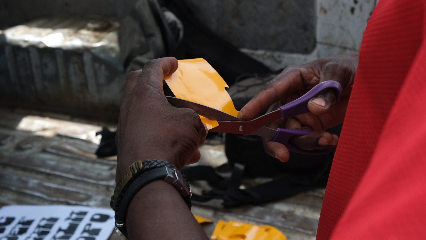 Abu, a lettering artist, cutting out the letters from vinyl sticker | Credit: Afrotype