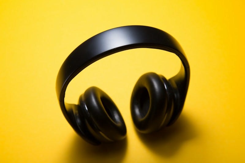 Photo of headphones on a yellow background