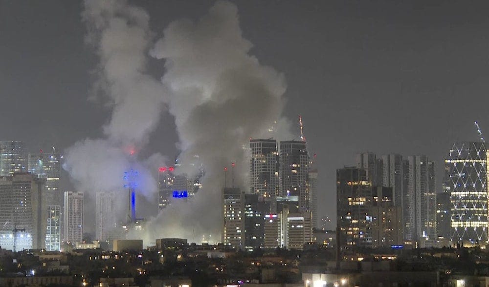 Smoke rises after an Iranian ballistic missile directly struck Tel Aviv, Occupied Palestine, June 13, 2025 (AP) Smoke rises after an Iranian ballistic missile directly struck Tel Aviv, Occupied Palestine, June 13, 2025 (AP)