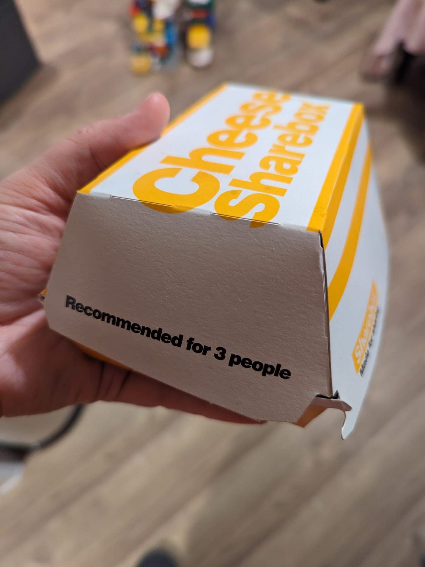 A Cheese Sharebox from McDonalds that erroneously states it's suitable for 3 people to share