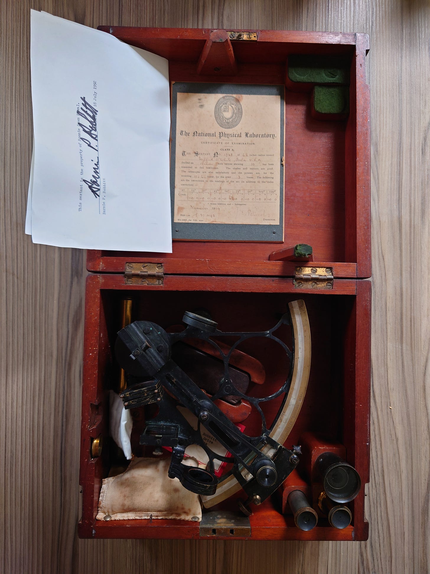 Photo of a sextant from the early 1900s in its protective wooden case with its certificate