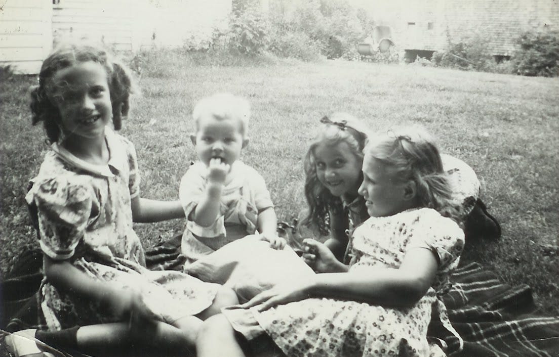 Four children on blanket