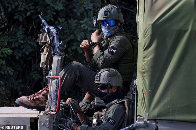 Israeli soldiers ready their kit, amid cross-border hostilities between Hezbollah and Israel, in northern Israel October 1, 2024