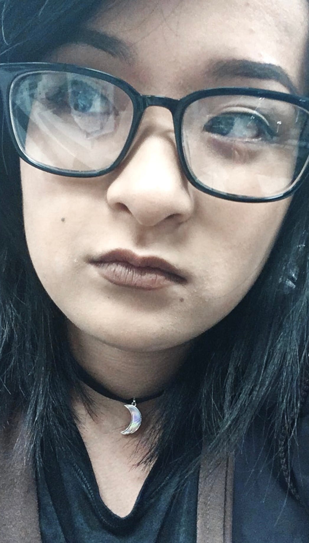a close-up picture of me, wearing big eyeglasses and a brown matte lipstick