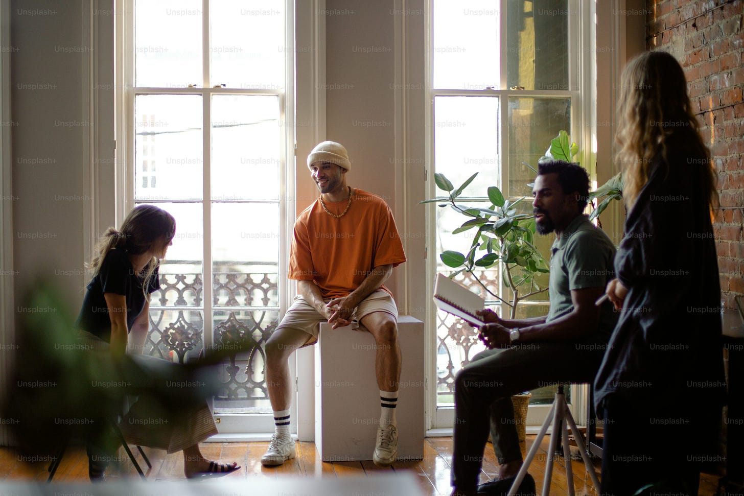 a group of people sitting around a window