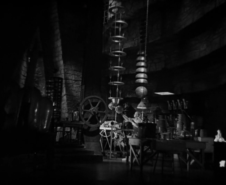 A black and white screenshot of Dr. Pretorius working in the lab.