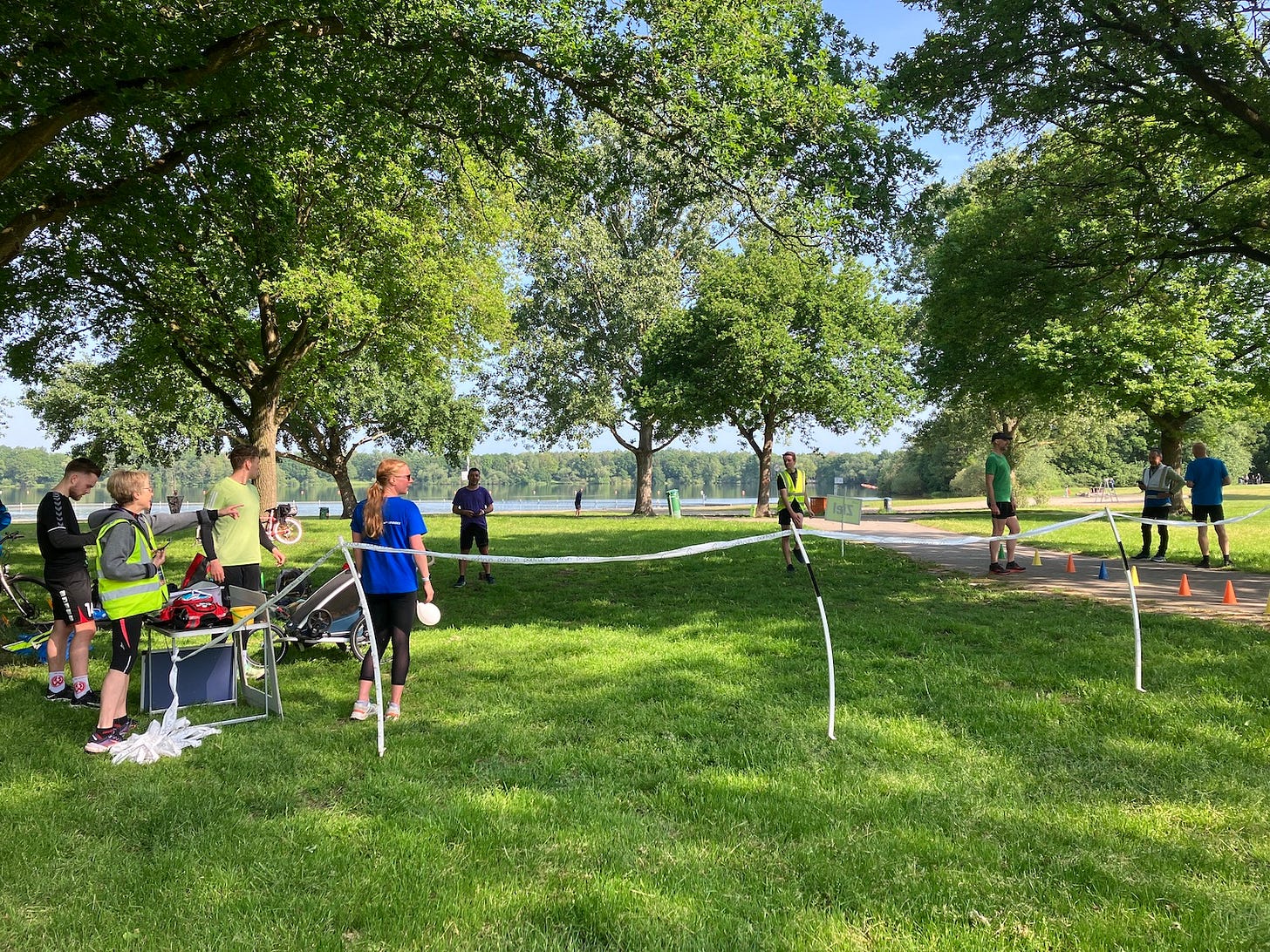 Finish area marked by tape and cones, sheltered by trees