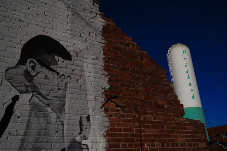 A Prichard water tower stands near downtown Prichard, Ala., on Wednesday, Dec. 6, 2023. The economically stressed city loses about 60% of its drinking water through leaks in its decrepit distribution system. Communities nationwide lose trillions of gallons. (AP Photo/Brynn Anderson)
