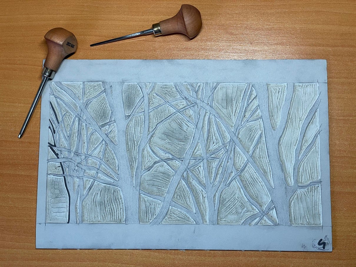 Photo: Block of lino with a design carved out.