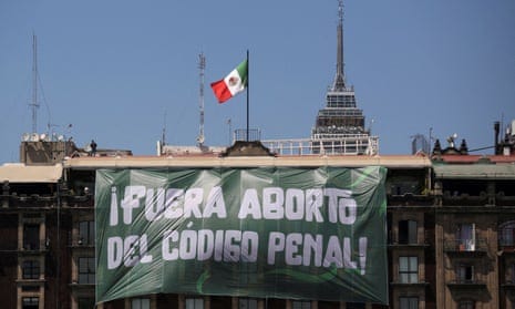A banner reading: ‘Abortion Out of the Penal Code’ hangs from a building during International Women's Day, at the Zocalo Square in Mexico City.