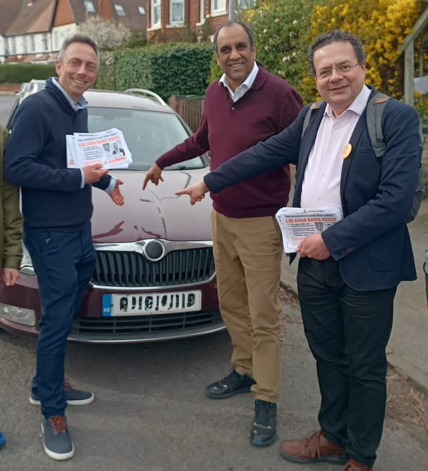 Mike Ross, Shaffaq Mohammed and Mark Pack pointing at a red car