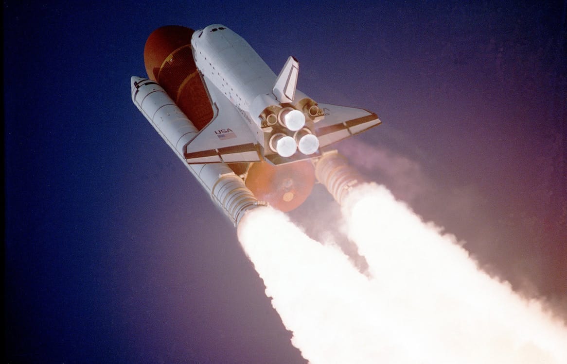 Free A space shuttle launches into space, showcasing powerful rocket engines and USA branding. Stock Photo