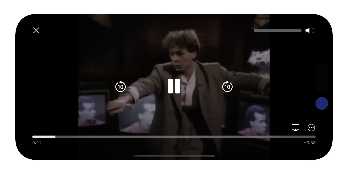 An iPhone playing a video of Simple Minds in full-screen while on landscape orientation.