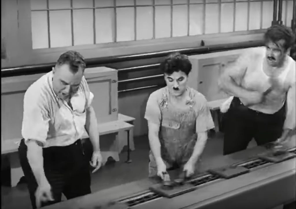 Still shot from Charlie Chaplin's "Modern Times" illustrating high demands, low resources, no social support on an assembly line.
