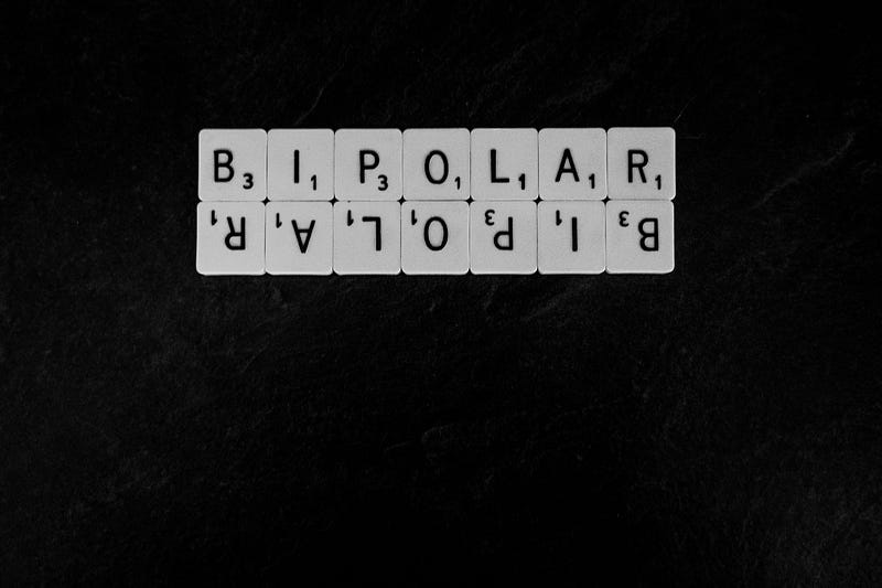 Scrabble tiles against a black background spelling out “bipolar” twice, once upside don