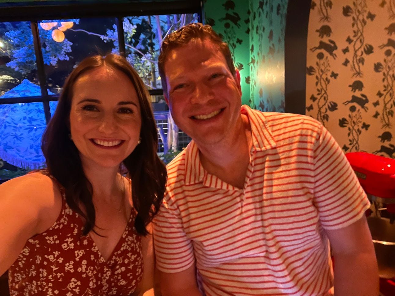 A couple sitting next to each other and smiling for a selfie A couple sitting next to each other and smiling for a selfie