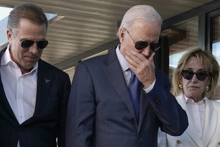 President Biden stands with his son Hunter Biden, on left, and sister Valerie Biden Owens, on right, as he looks at a plaque dedicated to his late son, Beau Biden, while visiting Mayo Roscommon Hospice in County Mayo, Ireland, on April 14.