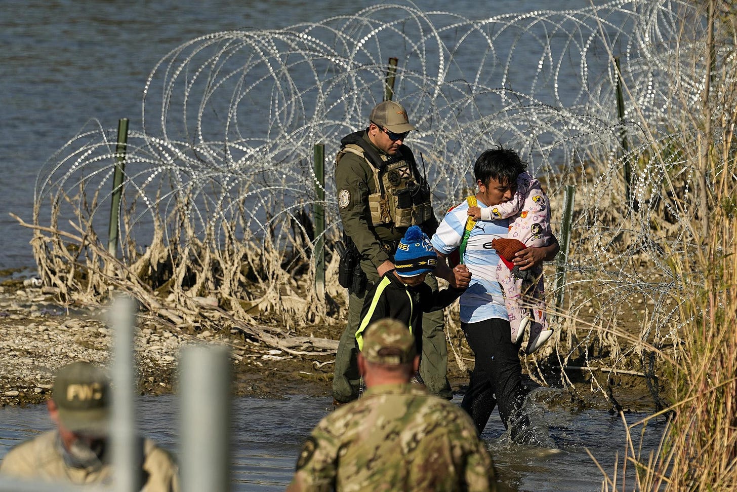A migrant and his children are taken into custody in Texas.