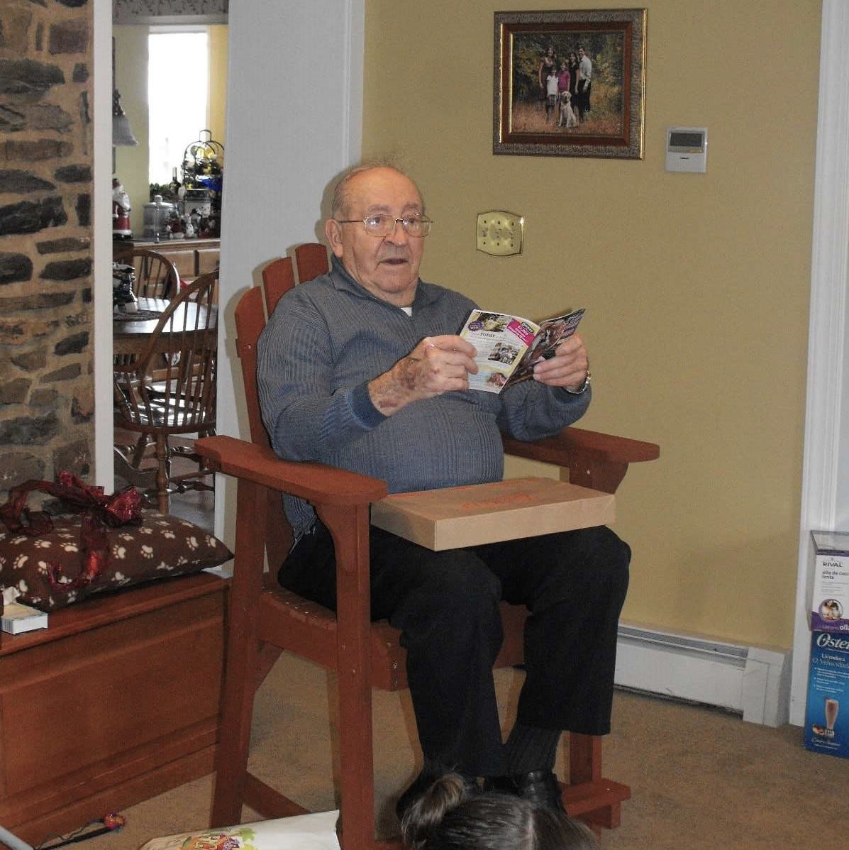 85-year-old uncle sits in his Christmas gift--an Adirondack chair that's a comfortable height
