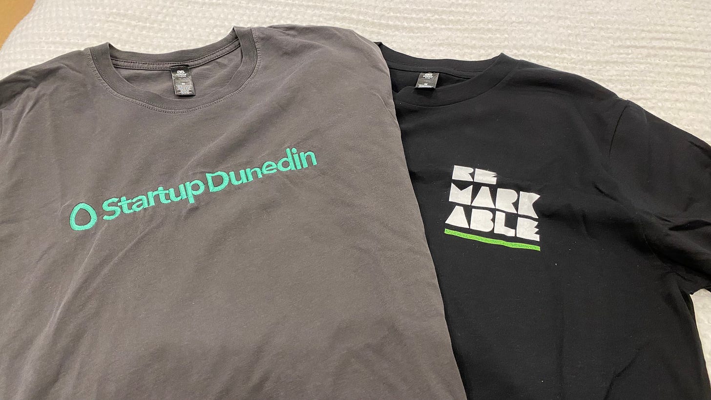Photo of two t-shirts: Startup Dunedin, and Remarkable