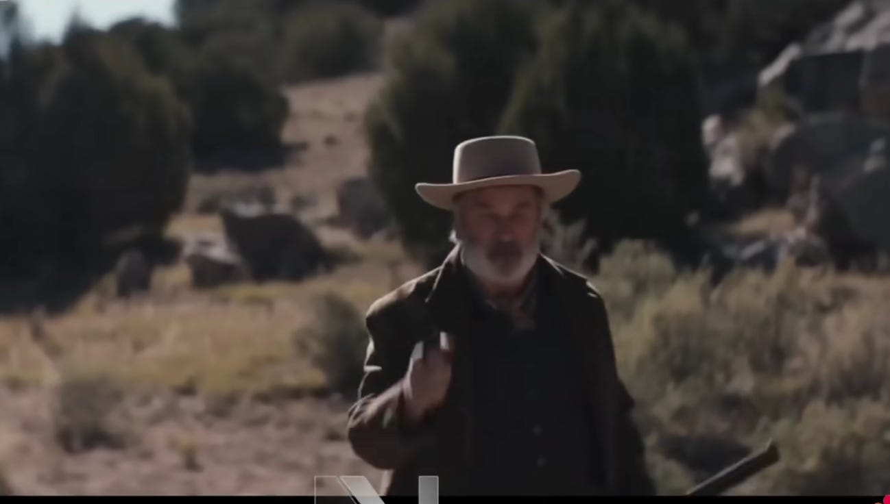 Baldwin with his finger on the trigger poining at the camera