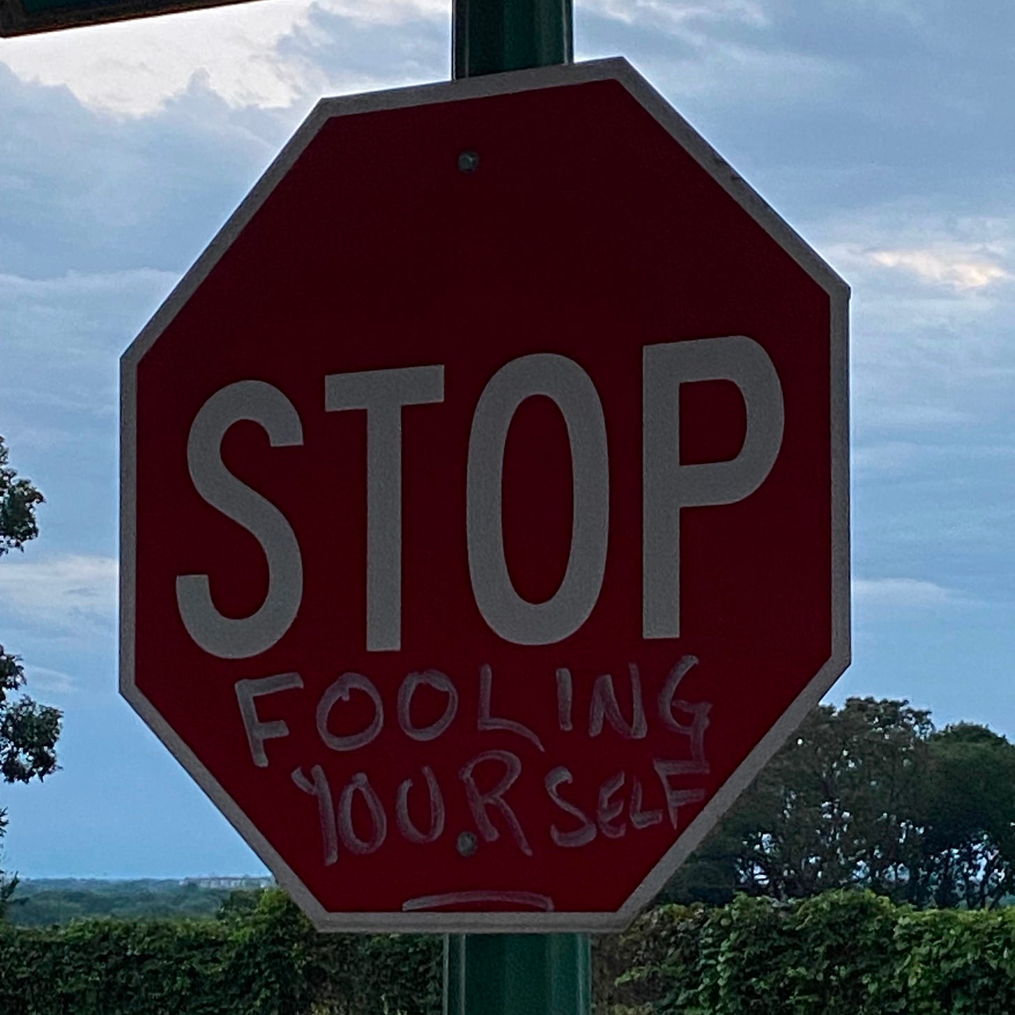 A stop sign that reads "Stop fooling yourself."