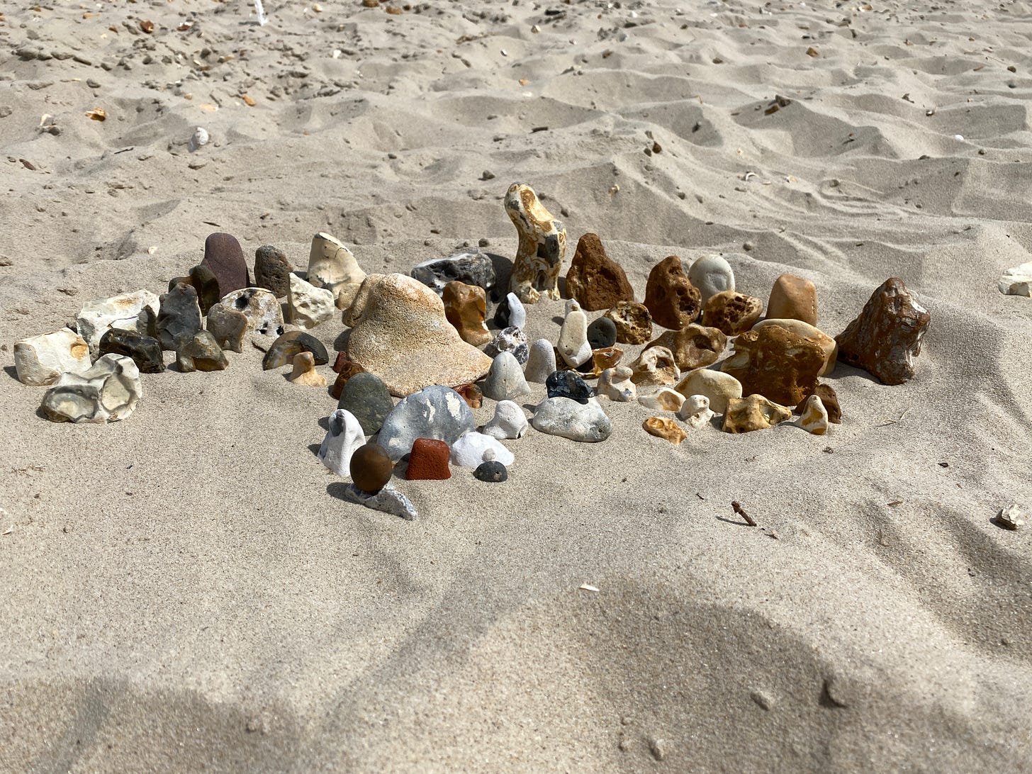 arrangement of stones on a sandy beach