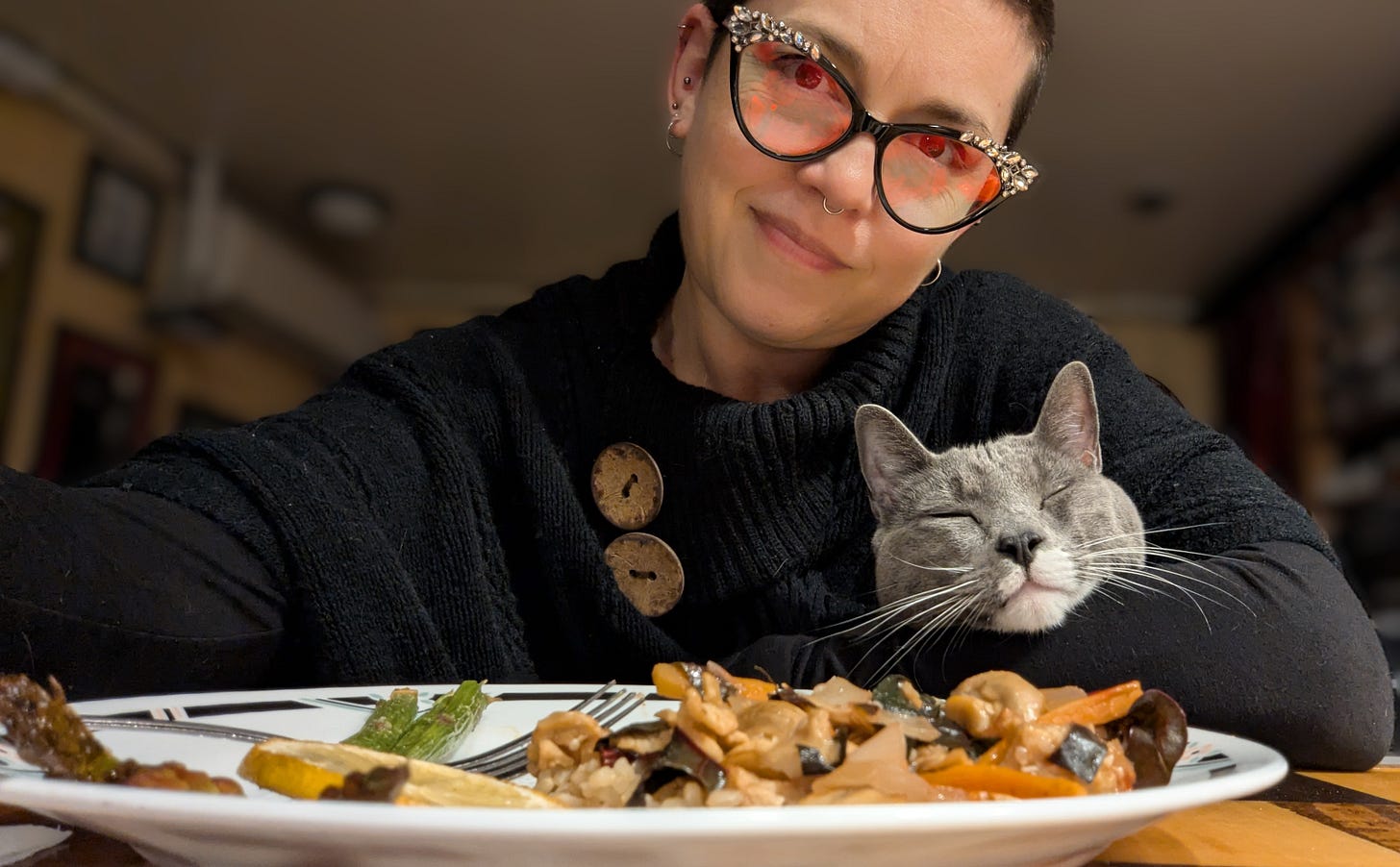 The author with a very happy grey cat and dinner