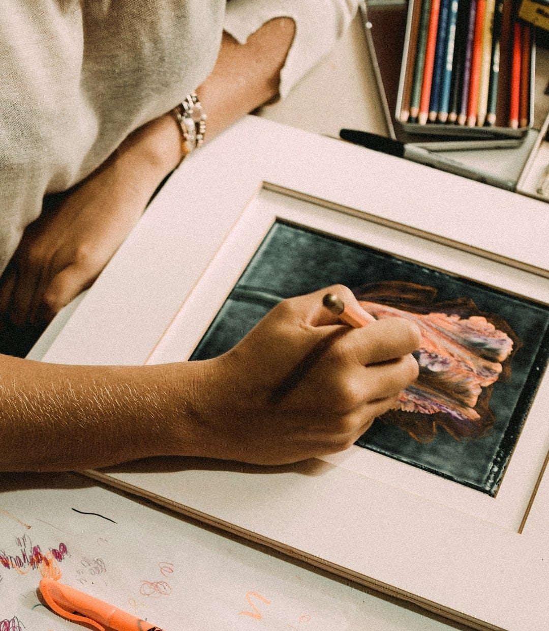person holding white framed painting person holding white framed painting