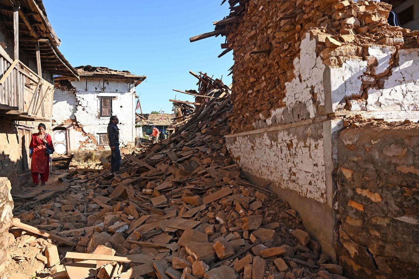 A man looks at damage from the earthquake. (Prakash Mathema/AFP/Getty Images)