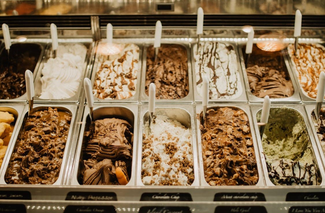 Free A close-up view of various gelato flavors in trays at a store. Stock Photo