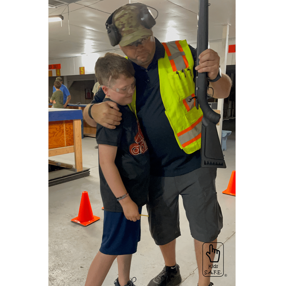 Man and boy with a Ruger American Rimfire at safety training.