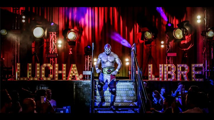 A Lucha Libre participant posing at the steps into the ring