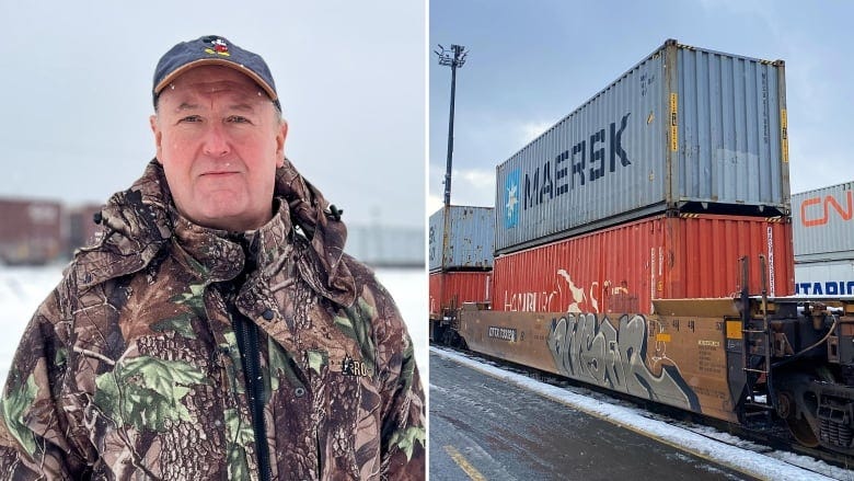 A man stands next to shipping containers. 