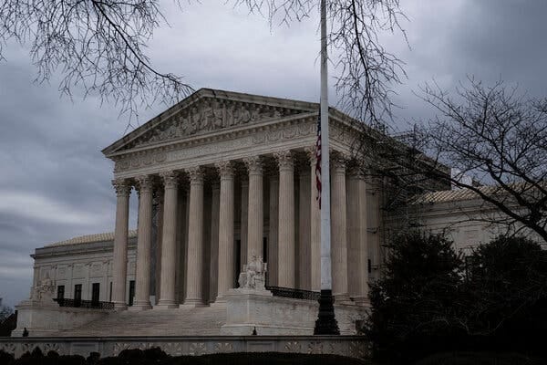 The Supreme Court building in Washington on a cloudy day.