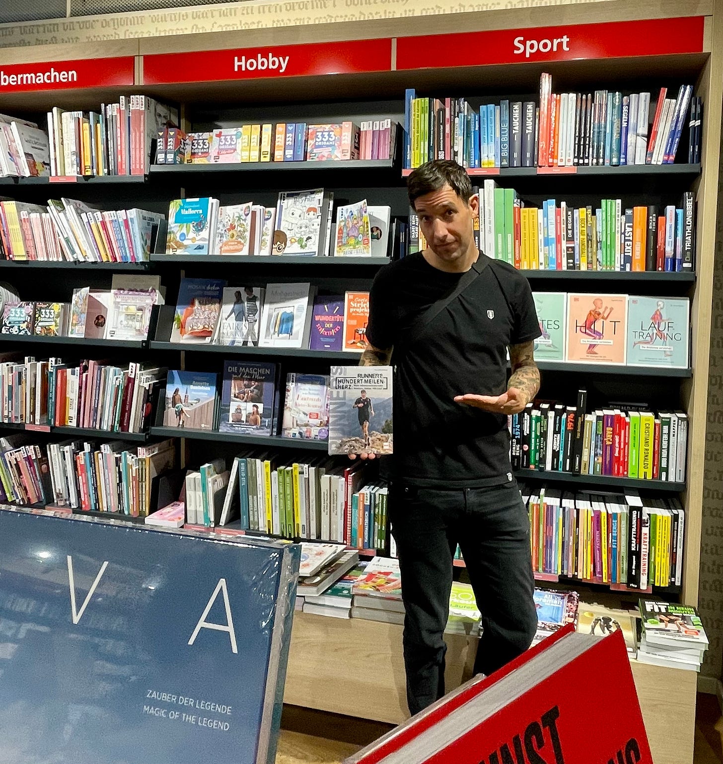 the author at a book store holding his own book in his hands