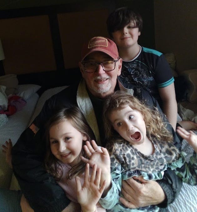 Photo of my with my ten year old grandson and his 8 and 6 year old sisters. 