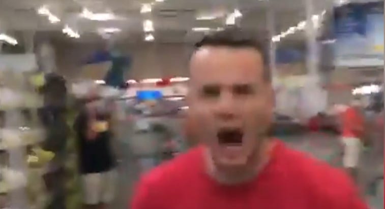 Blurry image of a guy in a grocery store with his mouth open in a scream.