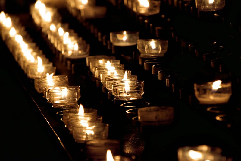 Rows of small lit candles.