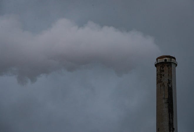 Smoke leaves a smokestack from the NIPSCO Michigan City plant on Tuesday, Jan. 27, 2021 in downtown Michigan City, Ind. 