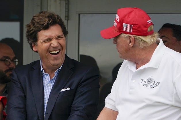 Tucker Carlson and former President Donald Trump are pictured interacting. 