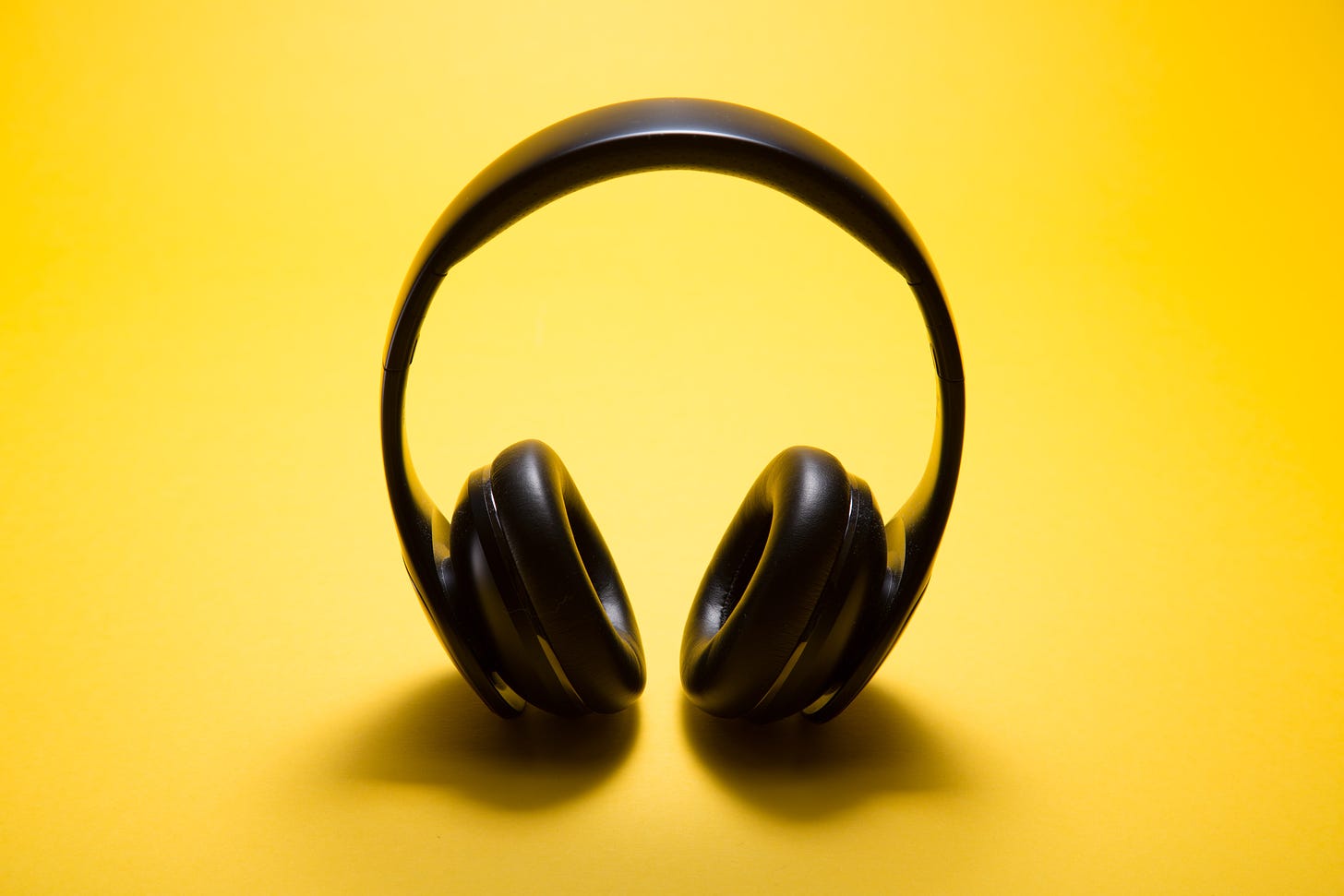 black headphones, yellow background